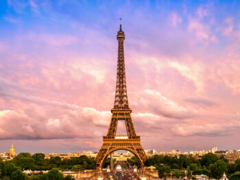 Eiffel Tower with pink and blue sunset behind it