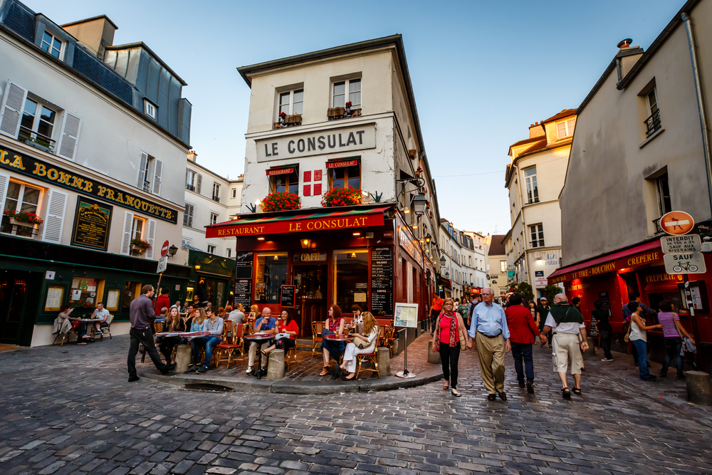 View of typical paris cafe in Paris. Montmartre area is among most popular destinations in Paris, Le Consulat is a typical cafe.