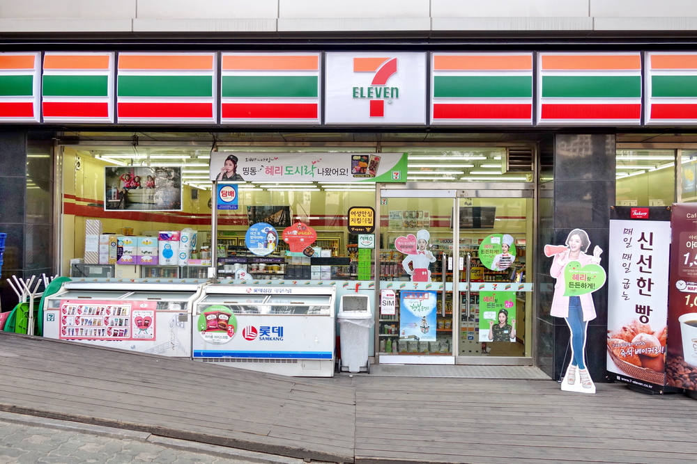 Entrance to a 7 Eleven with signs in Korean.