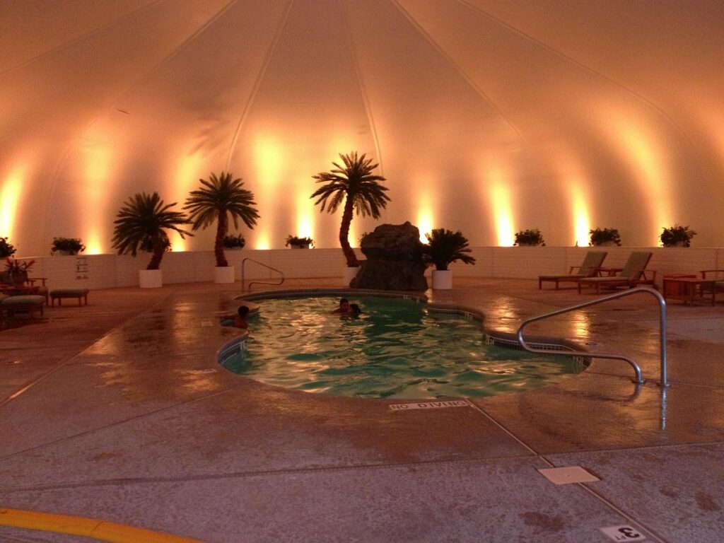 indoor pool with people in and ambient lighting. 