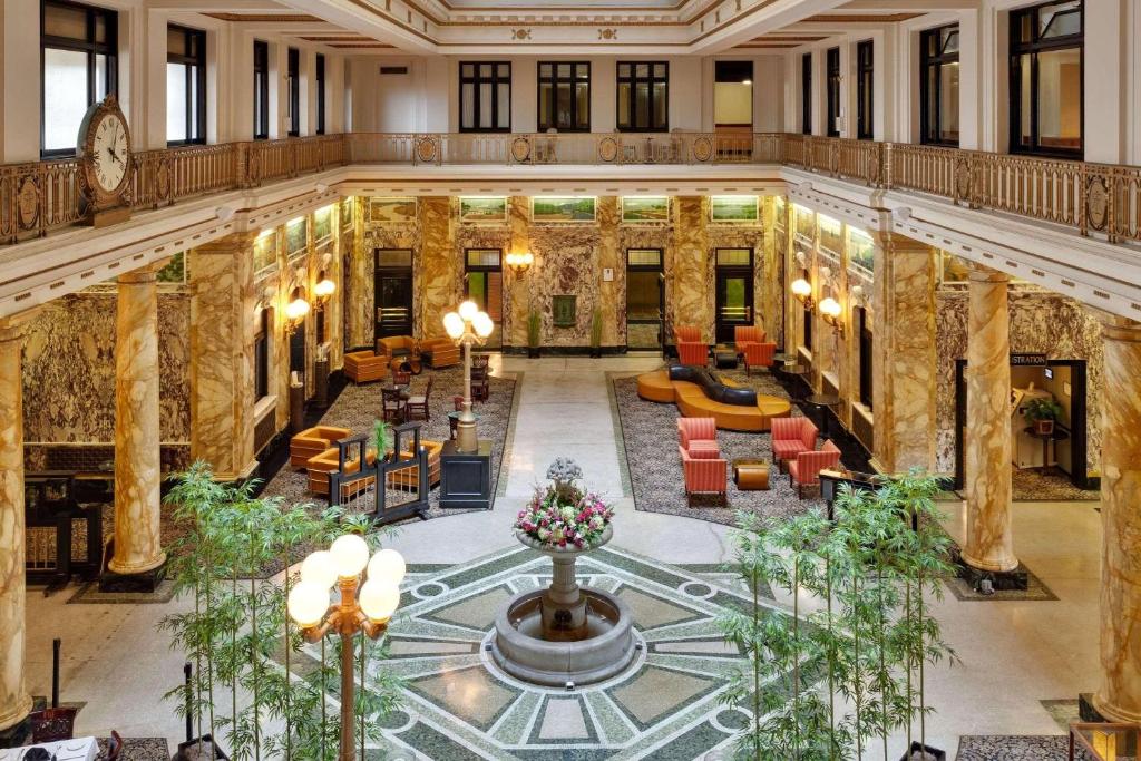 This large ornate lobby is perfect for romantic getaways in the Poconos. There are large marble columns an ornate floor and unusual chairs and sofas.  