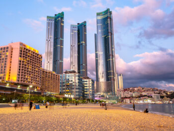 Sunset over skyscrapers over Haeundae Beach, one of the Best Places to Visit in Busan, South Korea.