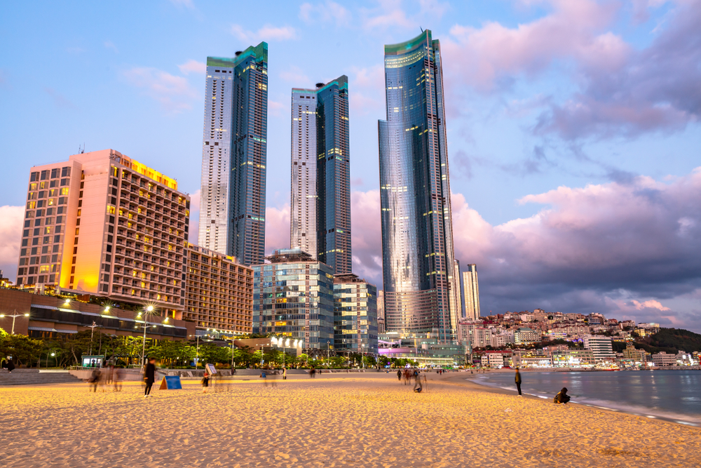 Sunset over skyscrapers over Haeundae Beach, one of the Best Places to Visit in Busan, South Korea.