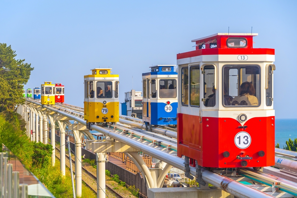 The colorful Haeundae Sky Capsule cars on an elevated railway, one of the best places to visit in Busan.