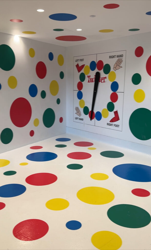 The Twister room at the TWA hotel at JFK. It's a room with a huge Twister game wheel and spots all over. 