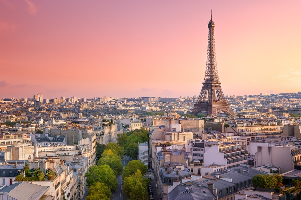 Cityscape of Paris with Eiffel Tower at sunset. The article is about 50th birthday trip ideas. 