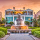 fountain surrounded by garden in front of beautiful building