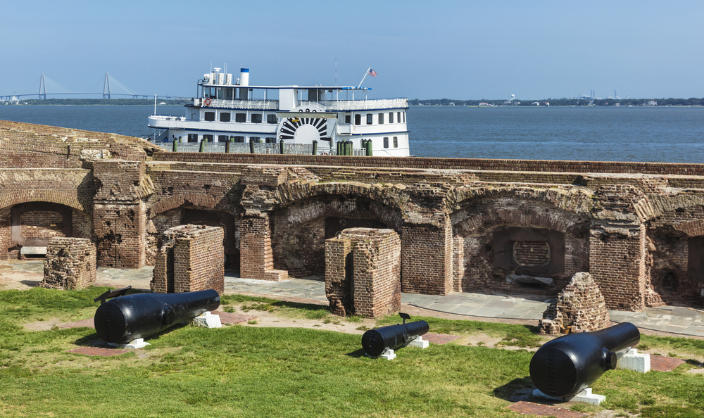 Two 15 inch 50,000-pound Rodman canons (on the sides), the largest guns used in the Civil War are on display at the Fort Sumter site. A boat is in the background. 