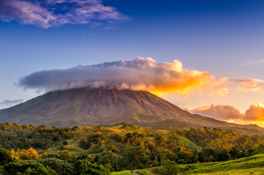 Arenal volcano under the clouds, Costa Rica at sunset. 