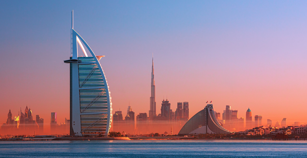 Dubai city - amazing city center skyline and famous Jumeirah beach at sunset, United Arab Emirates. 