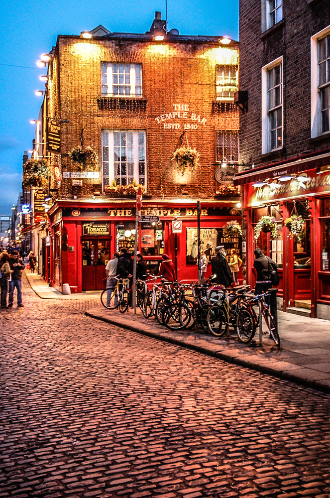 The Temple Bar district in central Dublin at night. Temple Bar has preserved its medieval street pattern, with many narrow cobbled streets. A perfect 30th birthday trip ideas