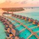 overwater bungalows surrounded by emerald green waters