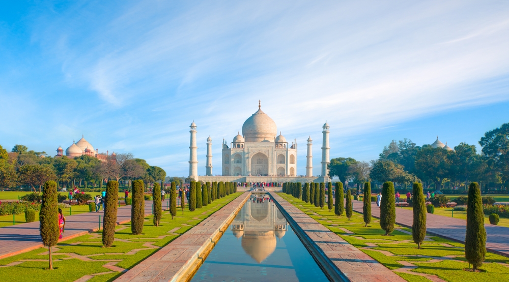 Amazing view on the Taj Mahal with reflection in water at sunny day - Agra, Uttar Pradesh, India. The article is about 40th birthday vacation ideas