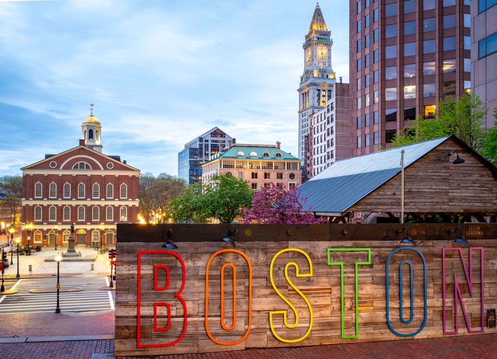 The architecture of Boston in Massachusetts, USA at sunrise at Government Center with the famous Faneuil Hall and the name of the city in big letters.