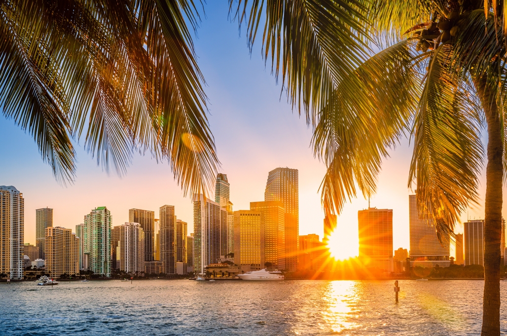 Miami, Florida skyline with sunbeams shining through the skyscrapers. Miami is a majority-minority city and a major center and leader in finance, commerce, culture, arts, and international trade.