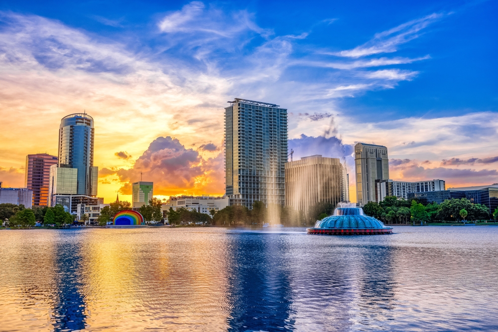 Sunset and clouds over the Orlando skyline and fountain at Lake Eola Park, Orlando FL