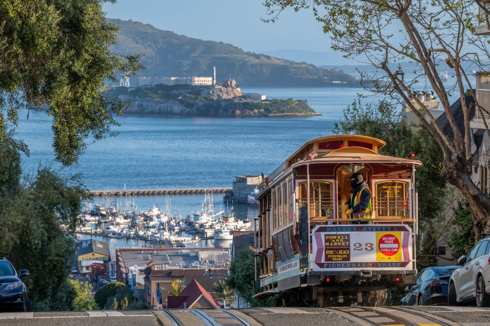 San Francisco Cable Cars at Daybreak, you can see the wharf and Alcatraz in the background. One of the cities to visit in America. 