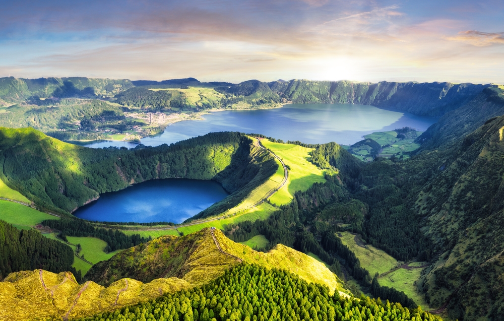 View looking down at the beautiful lakes on an island in the Azores with lush, green mountains.