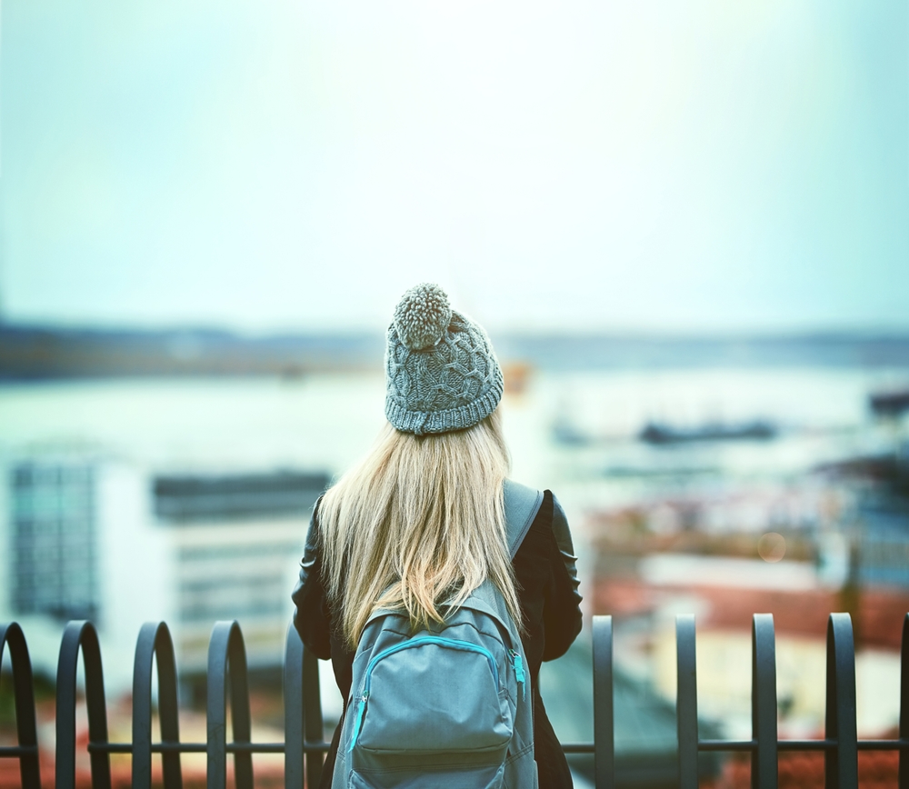 picture taken from the back of a girl with a bobble hat on looking over London in winter