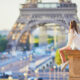 women in shirt and shorts sitting and watching eiffel tower what to wear in paris in summer