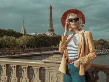 woman wearing checked top with blue jeans and yellow light jacket