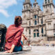 woman backpacker sitting outside a religious site traveling to spain