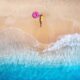 aerial view of a girl lying on the beach traveling to the maldives
