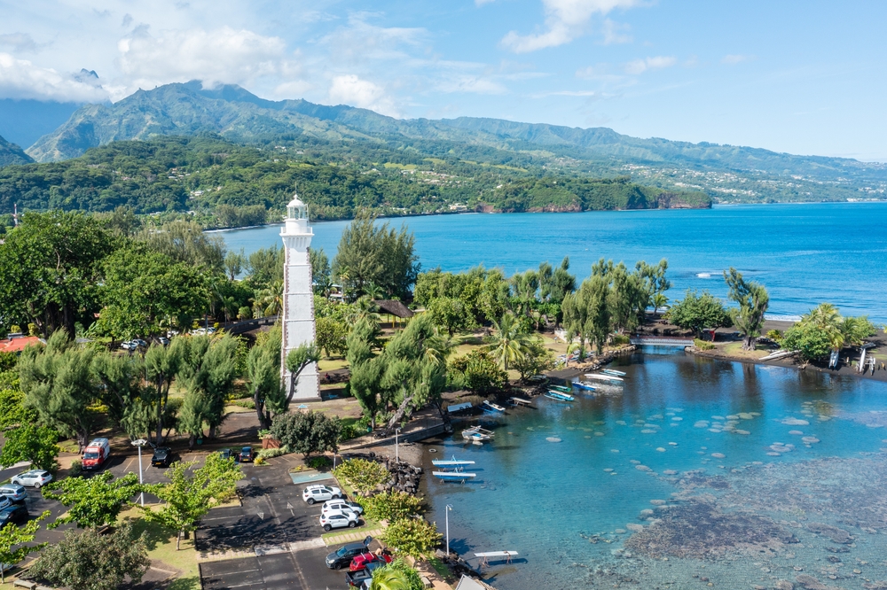 Aerial image of a white lighthouse near to the ocean in Papeete, Tahiti.