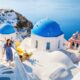 girl walking the white steps with white buildings and blue domes beside it the greek islands