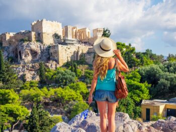 woman tourist looking at the acropolis ruins traveling to athens