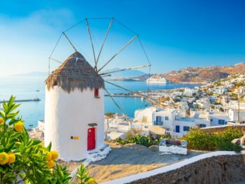 windmill on a height with view of the coastal town