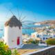 windmill on a height with view of the coastal town
