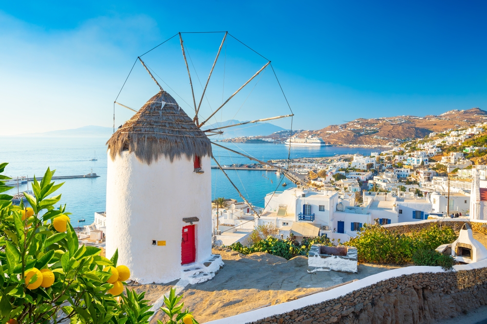 windmill on a height with view of the coastal town