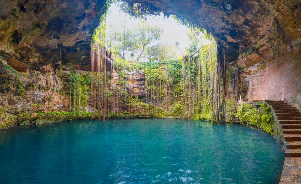 Spring waters in center with large opening showing the sky and greenery hanging