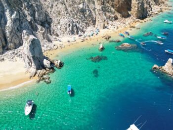 aerial view of a beach beside a cliff warm weather getaways