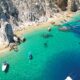 aerial view of a beach beside a cliff warm weather getaways