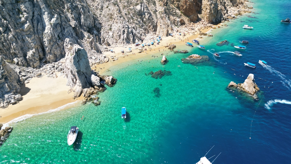 aerial view of a beach beside a cliff warm weather getaways