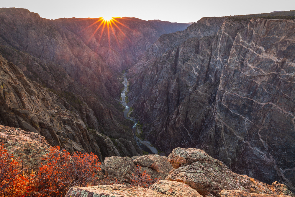 sunrise over the black canyon of gunnison. You can see the canyon and the river below.  