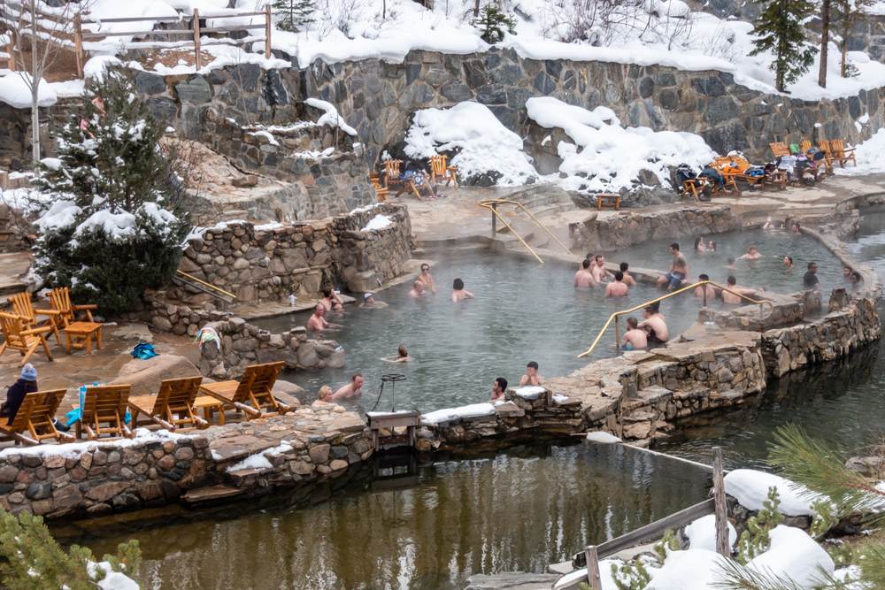 Steamboat Springs, Colorado.  People enjoy the outdoor Stawberry Park Hot Springs, to relax in the hot water after a day of skiing on the nearby slopes of Mount Werner.