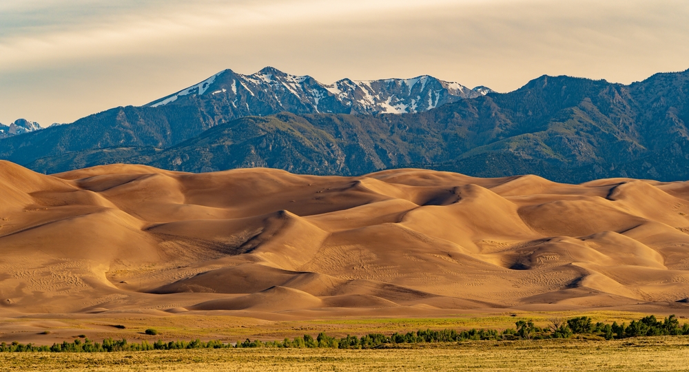 Sunny view of the landscape of Great Sand Dunes National Park and Preserve at Colorado. The article is about a Colorado road trip.