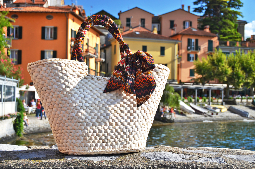 Basket bag against old houses in Varenna town at the lake Como, Italy