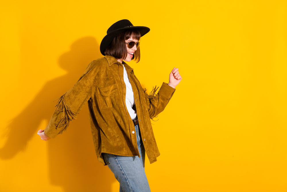 Photo of cute sweet woman dressed cowboy clothes dark spectacles cap smiling dancing