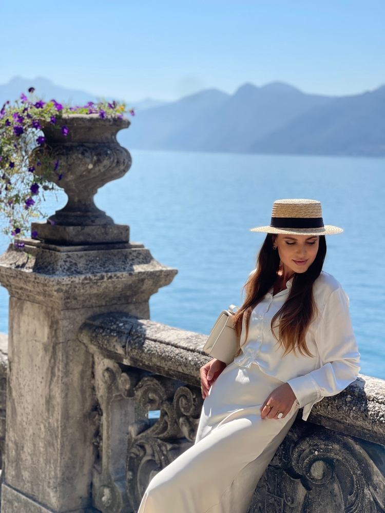 Caucasian woman in front of water with mountain in background