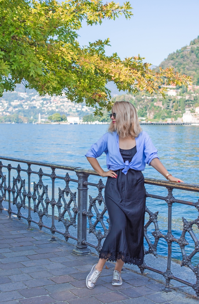 Vacation in Italy. Concept of tourism and holidays. Woman in landscape scene. Article is about Lake Como outfits. 