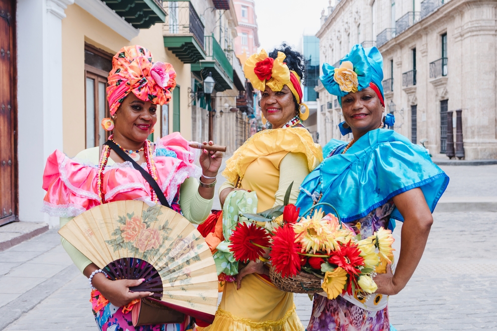 Cuban women called canasteras with habano flowers and typical costume in La Havana, Afro caribbean people in Latin America. The article is about traveling to Cuba