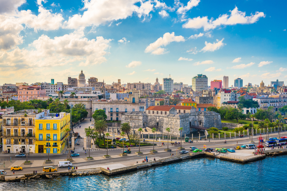 Havana, Cuba downtown skyline on the Malecon. The article is about traveling to Cuba.