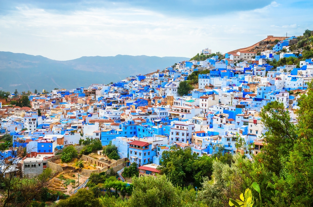 aerial view of city with blue houses traveling to morocco