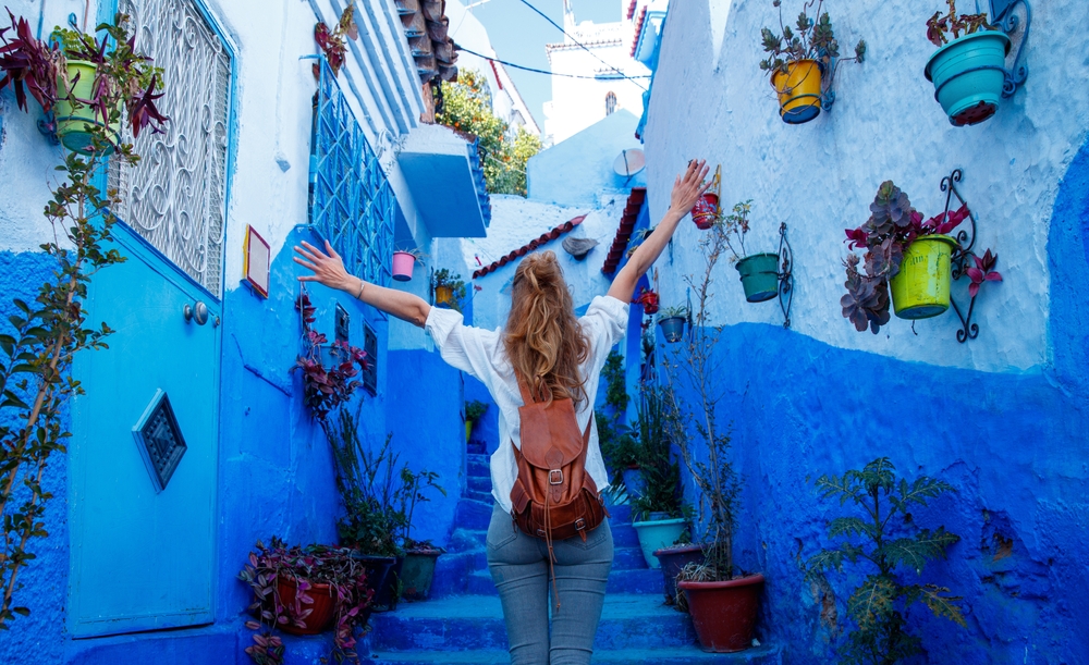 woman standing in a blue colored street