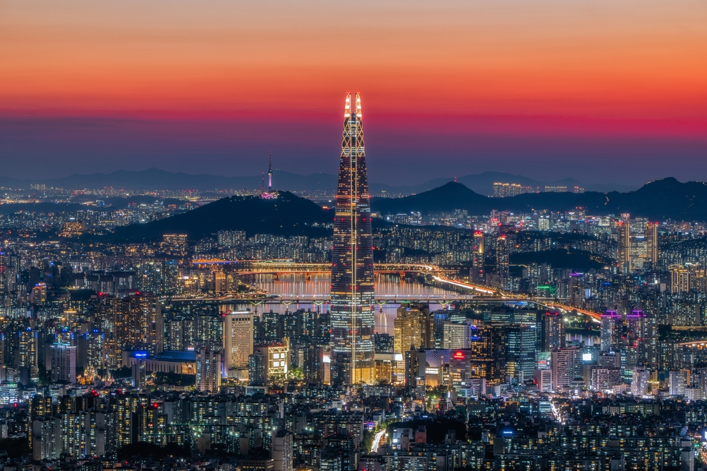 sunset over a city with a long tower in the middle things to do in seoul