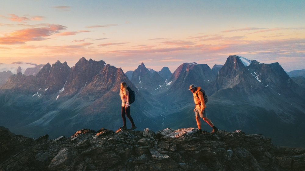 a girl and man hiking in the mountains